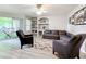 Living room with sectional sofa, built in shelving, and hardwood floors at 7350 Westpointe Blvd # 224, Orlando, FL 32835