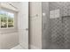 Bathroom leading to bedroom with sleek glass-enclosed shower, modern finishes, and stylish tile work at 7399 Gathering Ct, Reunion, FL 34747
