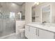 Modern bathroom features glass shower door, gray tiles, and a sleek vanity at 7399 Gathering Ct, Reunion, FL 34747