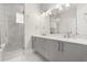 Elegant bathroom featuring a double sink vanity and a frameless glass shower at 7399 Gathering Ct, Reunion, FL 34747