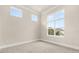 Bright bedroom featuring neutral walls, large windows, and base molding at 7399 Gathering Ct, Reunion, FL 34747