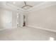 Spacious bedroom with tray ceiling, recessed lighting, plush carpet, and white trim throughout at 7399 Gathering Ct, Reunion, FL 34747