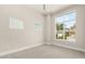 Airy bedroom featuring large windows, neutral paint, modern carpet, and exterior views at 7399 Gathering Ct, Reunion, FL 34747