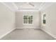 Bright bedroom with ceiling fan, plush carpet, and two windows offering plenty of natural light at 7399 Gathering Ct, Reunion, FL 34747