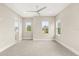 Spacious bedroom with multiple windows, ceiling fan, and neutral tones at 7399 Gathering Ct, Reunion, FL 34747