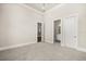 Expansive bedroom featuring neutral walls, multiple doors, and plush carpeting at 7399 Gathering Ct, Reunion, FL 34747