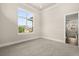 Large bedroom with a view, plush carpeting, and neutral walls and trim at 7399 Gathering Ct, Reunion, FL 34747