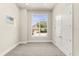 Bright bedroom with large windows, neutral walls, plush carpeting, and a spacious closet at 7399 Gathering Ct, Reunion, FL 34747