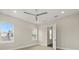 Bright bedroom featuring neutral walls, ceiling fan, and multiple windows for natural light at 7399 Gathering Ct, Reunion, FL 34747