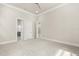 Spacious bedroom featuring plush carpeting and doorway views into the ensuite bathroom at 7399 Gathering Ct, Reunion, FL 34747