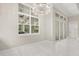 Bright dining room featuring a modern chandelier, large windows, and glass sliding doors at 7399 Gathering Ct, Reunion, FL 34747