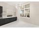 Dining room with modern chandelier, gray cabinets, and view to the outdoor patio at 7399 Gathering Ct, Reunion, FL 34747