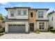 Stunning two-story home featuring a stone facade, manicured landscaping, and a spacious two-car garage at 7399 Gathering Ct, Reunion, FL 34747