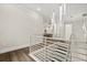 Hallway showcasing modern lighting fixtures, wood floors, and a white railing at 7399 Gathering Ct, Reunion, FL 34747
