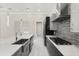 Contemporary kitchen with stainless steel appliances, quartz countertops, and stylish backsplash at 7399 Gathering Ct, Reunion, FL 34747