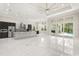 Expansive kitchen featuring stainless steel appliances, a large island, and glass sliding doors leading to the pool area at 7399 Gathering Ct, Reunion, FL 34747