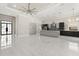 Modern kitchen with marble floors, stainless steel appliances, and a large center island, perfect for entertaining at 7399 Gathering Ct, Reunion, FL 34747