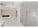 Open living area featuring white tile floor, electric fireplace, and custom gray cabinet build-ins at 7399 Gathering Ct, Reunion, FL 34747