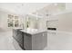 Bright, open concept living space with large island, and a modern fireplace, seamlessly connecting the kitchen and living area at 7399 Gathering Ct, Reunion, FL 34747
