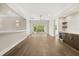 Open living space featuring hardwood floors, sliding glass doors, and elegant bar area at 7399 Gathering Ct, Reunion, FL 34747