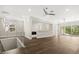 Upstairs living area featuring hardwood floors, bar area, and sliding doors to a balcony at 7399 Gathering Ct, Reunion, FL 34747