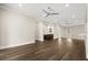 Spacious living room with hardwood floors, stylish wet bar, and contemporary ceiling fans at 7399 Gathering Ct, Reunion, FL 34747