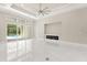 Bright living area with modern fireplace, sliding glass doors to the pool, and an elegant ceiling fan at 7399 Gathering Ct, Reunion, FL 34747