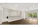 Upstairs living area with hardwood floors, open railing, and sliding doors to a balcony at 7399 Gathering Ct, Reunion, FL 34747