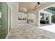 Large outdoor living space with fireplace, summer kitchen and direct view to pool area at 7399 Gathering Ct, Reunion, FL 34747