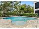 Backyard pool with jacuzzi and stone paver decking at 7399 Gathering Ct, Reunion, FL 34747