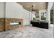 View of the outdoor kitchen area with granite countertops, stainless steel hood vent and outdoor fireplace at 7399 Gathering Ct, Reunion, FL 34747