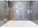 Modern bathtub featuring a shower head and stylish gray tile at 744 London Rd, Winter Park, FL 32792