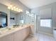 Bathroom with double vanity, shower, and separate tub at 8030 King Palm Cir, Kissimmee, FL 34747