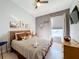 Cozy bedroom with wood dresser and striped bedding at 8030 King Palm Cir, Kissimmee, FL 34747