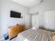 Spacious bedroom with wood dresser and large TV at 8030 King Palm Cir, Kissimmee, FL 34747