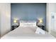 Primary bedroom with king bed and blue accent wall at 8030 King Palm Cir, Kissimmee, FL 34747