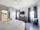 Main bedroom with ensuite bath and grey dresser at 8030 King Palm Cir, Kissimmee, FL 34747