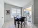 Bright breakfast nook with table and chairs, access to back patio at 8030 King Palm Cir, Kissimmee, FL 34747