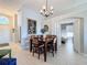 Dining area with wooden table, view of living room, and access to bedroom at 8030 King Palm Cir, Kissimmee, FL 34747