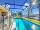 Inviting screened pool with expansive backyard views at 8030 King Palm Cir, Kissimmee, FL 34747