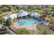 Aerial view of a resort-style pool with surrounding lounge chairs and cabanas at 8030 King Palm Cir, Kissimmee, FL 34747