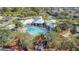 Aerial view of community pool and clubhouse with lush landscaping at 8030 King Palm Cir, Kissimmee, FL 34747