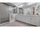 Elegant bathroom with dual vanities, granite countertop, and a large walk-in shower at 9085 Yonath St, Orlando, FL 32827