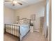 Charming bedroom featuring a metal bed frame and neutral decor at 9085 Yonath St, Orlando, FL 32827