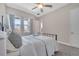 Cozy bedroom with a metal bed frame and soft window treatments at 9085 Yonath St, Orlando, FL 32827