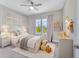 Charming bedroom with plush bedding, stylish decor, and plenty of natural light at 9085 Yonath St, Orlando, FL 32827
