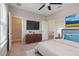 Comfortable bedroom featuring a dresser, TV and large bed at 9085 Yonath St, Orlando, FL 32827