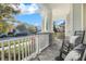 Front porch with rocking chairs, white columns, and a view of the neighborhood at 9085 Yonath St, Orlando, FL 32827