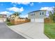 Two-car garage with a large driveway and wooden fence at 9085 Yonath St, Orlando, FL 32827