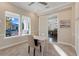 Home office with a desk, large windows, and a view of the front porch at 9085 Yonath St, Orlando, FL 32827